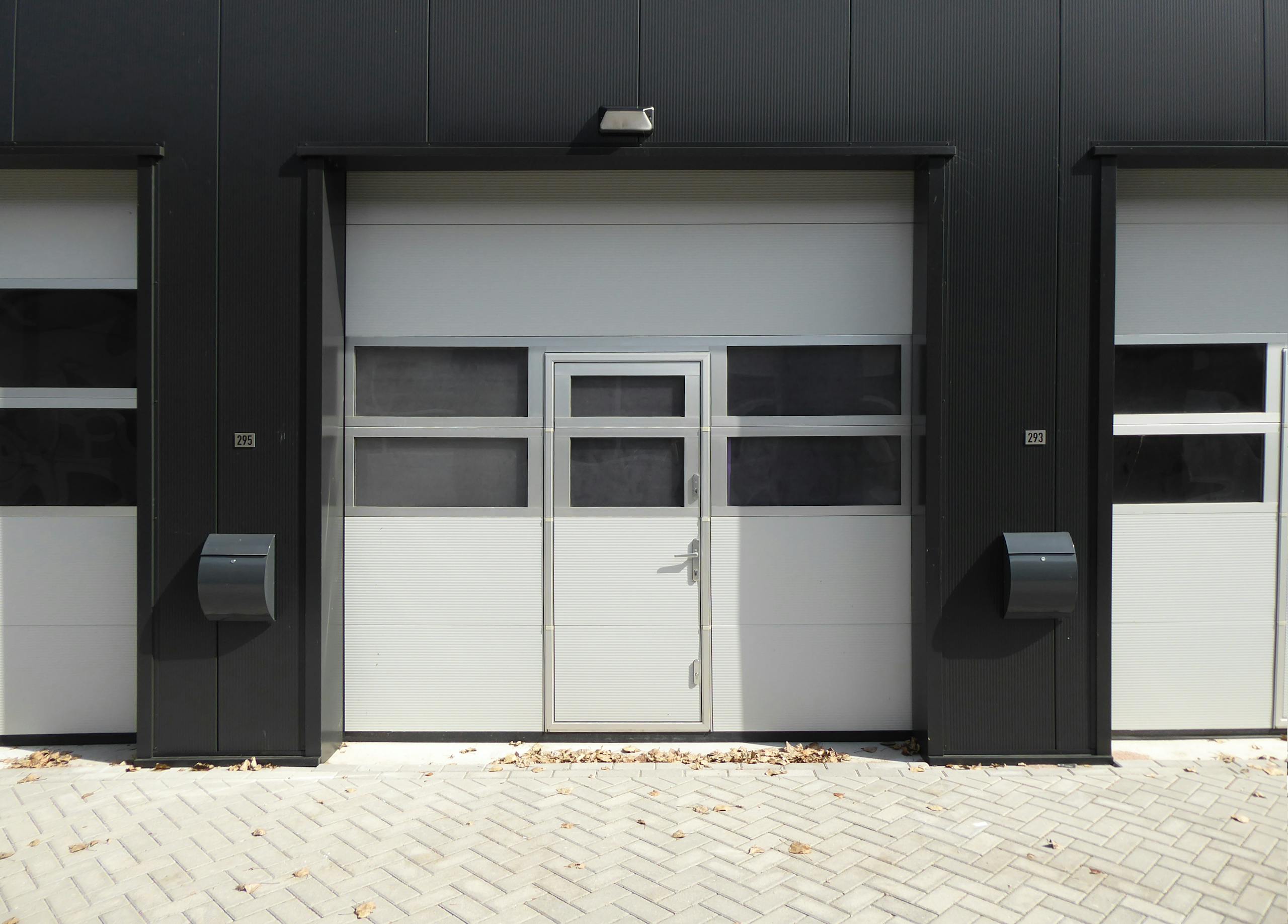 Modern industrial garage door with entrance, suitable for business property.